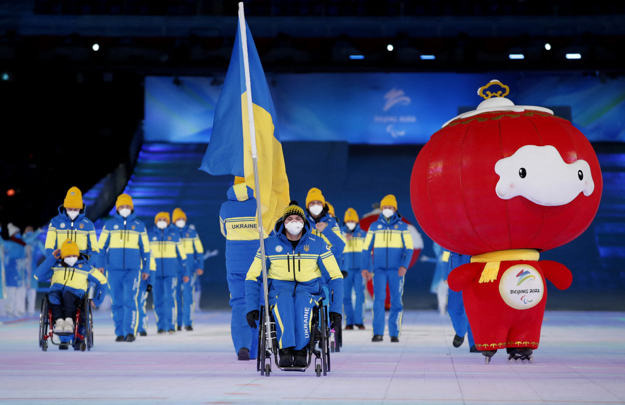 Beijing 2022 Winter Paralympic Games - Opening Ceremony - National Stadium, Beijing, China - March 4, 2022. Flagbearer Maksym Yarovyi of Ukraine leads his contingent during the athletes parade at the opening ceremony. 