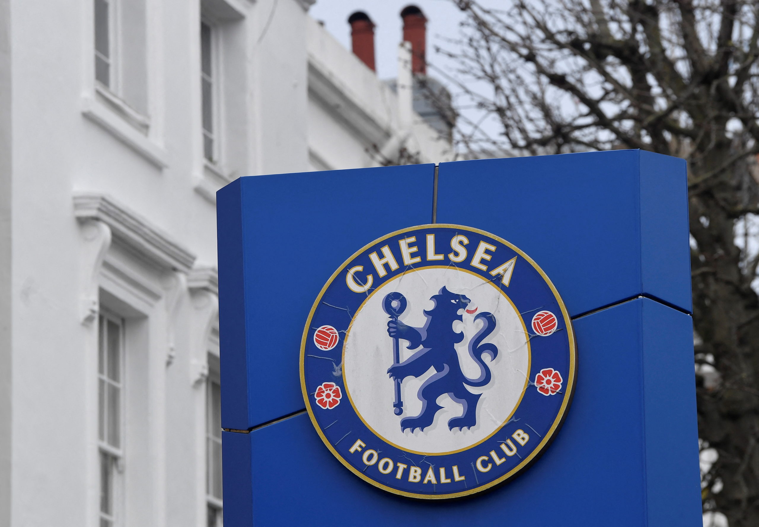 FILE PHOTO: A logo is seen at an entrance to Stamford Bridge, the stadium for Chelsea Football Club, after Russian businessman Roman Abramovich said on Wednesday that he would sell Chelsea, 19 years after buying it, as Russia's invasion of Ukraine continues, in London, Britain March 3, 2022. 