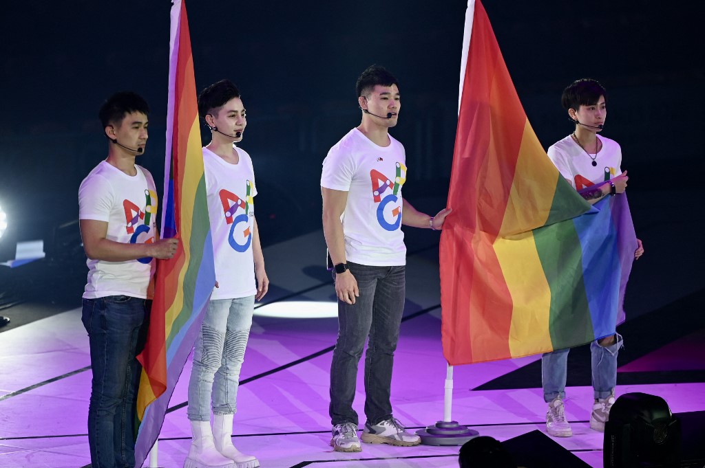 Athletes stand with rainbow flags during the opening ceremony of the Asia Pride Games in Taipei on April 29, 2022. (
