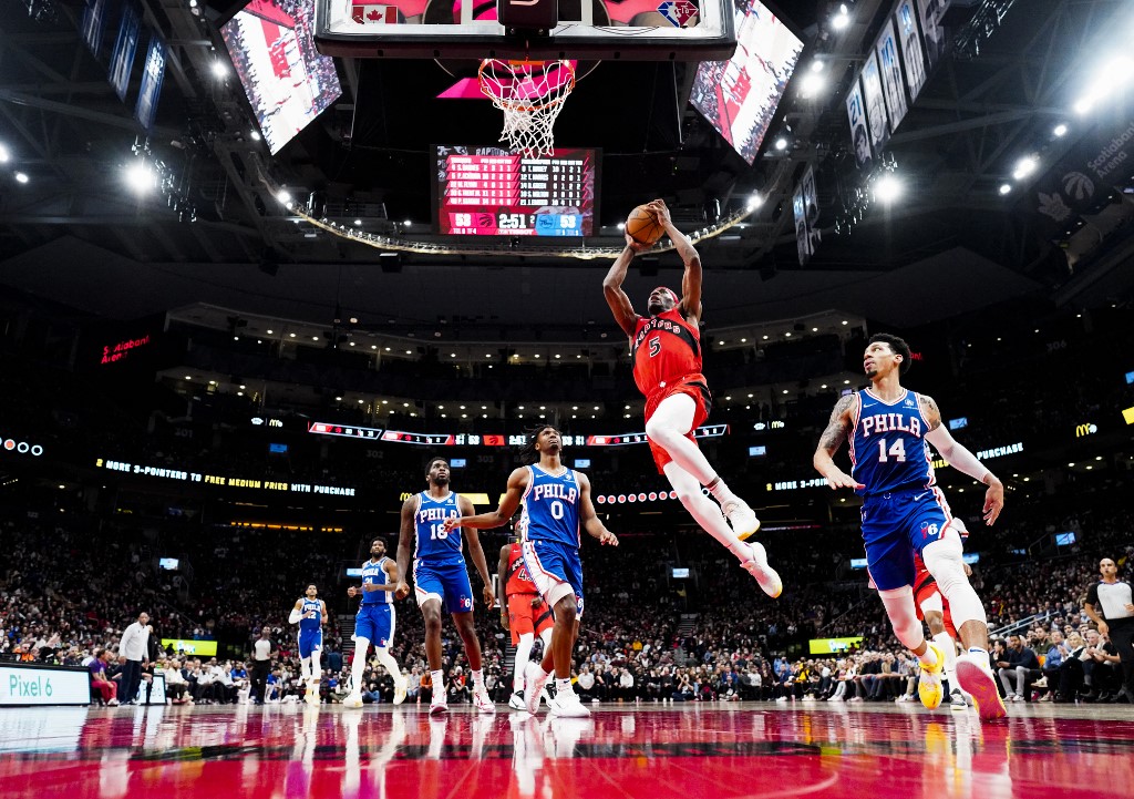 TORONTO, ON - APRIL 7: Precious Achiuwa #5 of the Toronto Raptors goes to the basket against Danny Green #14 of the Philadelphia 76ers during the second half of their basketball game at the Scotiabank Arena on April 7, 2022 in Toronto, Ontario, Canada.
