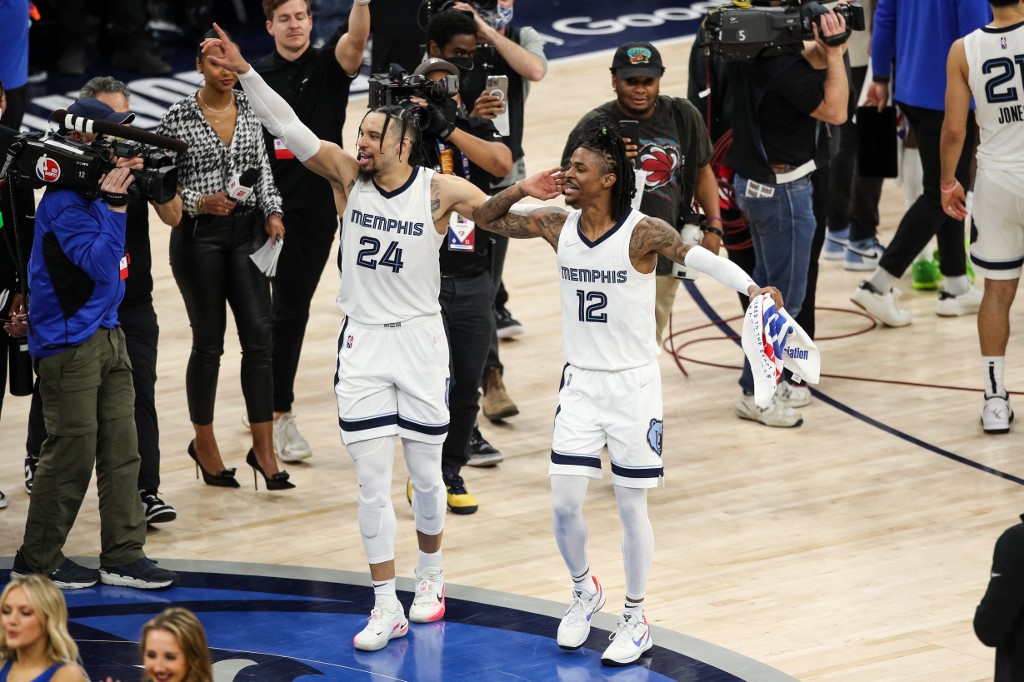 Dillon Brooks #24 and Ja Morant #12 of the Memphis Grizzlies celebrate a 114-106 victory against the Minnesota Timberwolves to advance to the Western Conference Semifinals after Game Six of the Western Conference First Round at Target Center on April 