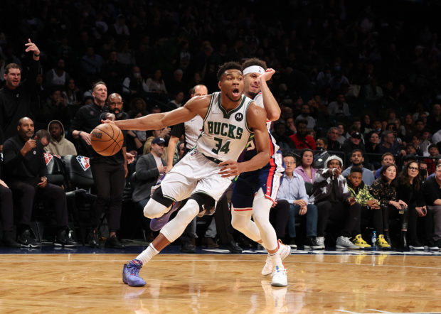 Giannis Antetokounmpo #34 of the Milwaukee Bucks drives against Seth Curry #30 of the Brooklyn Nets duri