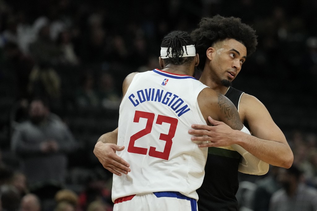 Robert Covington #23 of the LA Clippers and Jordan Nwora #13 of the Milwaukee Bucks hug after the Clippers defeated the Bucks 153-119 at Fiserv Forum on April 01, 2022 in Milwaukee, Wisconsin. 
