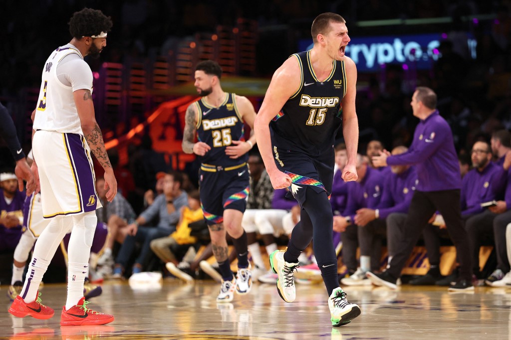 Nikola Jokic #15 of the Denver Nuggets reacts after scoring as Anthony Davis #3 of the Los Angeles Lakers looks on during the second half of a game at Crypto.com Arena on April 03, 2022 in Los Angeles, California. NOTE TO 