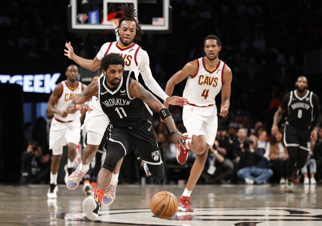 Kyrie Irving #11 of the Brooklyn Nets and Darius Garland #10 of the Cleveland Cavaliers chase a loose ball during the first half of the Eastern Conference 2022 Play-In Tournament at Barclays Center on April 12, 2022 in the Brooklyn borough of New York City.