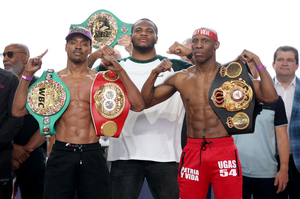 ARLINGTON, TEXAS - APRIL 15: (L-R) Errol Spence Jr. and Yordenis Ugas pose with Dallas Cowboys linebacker Micah Parsons (center) during the official weigh-in at Texas Live! on April 15, 2022 in Arlington, Texas.   T
