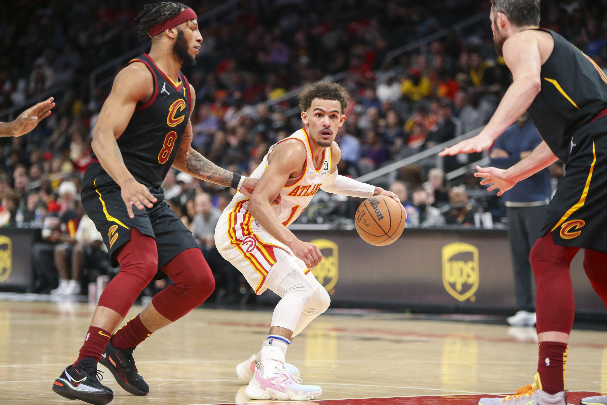 Mar 31, 2022; Atlanta, Georgia, USA; Atlanta Hawks guard Trae Young (11) is defended by Cleveland Cavaliers forward Lamar Stevens (8) in the second half at State Farm Arena. 