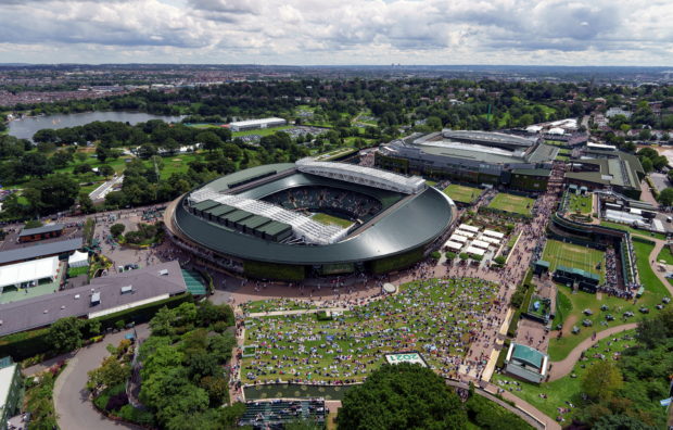 FILE PHOTO: Tennis - Wimbledon - All England Lawn Tennis and Croquet Club, London, Britain - July 5, 2021 General view as spectators watch a big screen outside court 1 during the fourth round Pool 