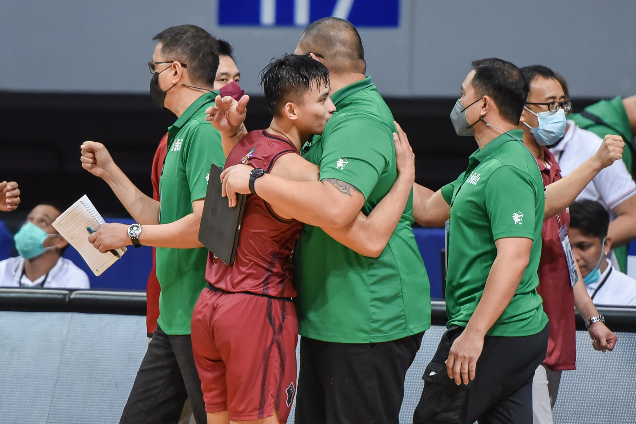 UP Fighting Maroons' Joel Cagulangan greets La Salle coaches after the game. UAAP PHOTO