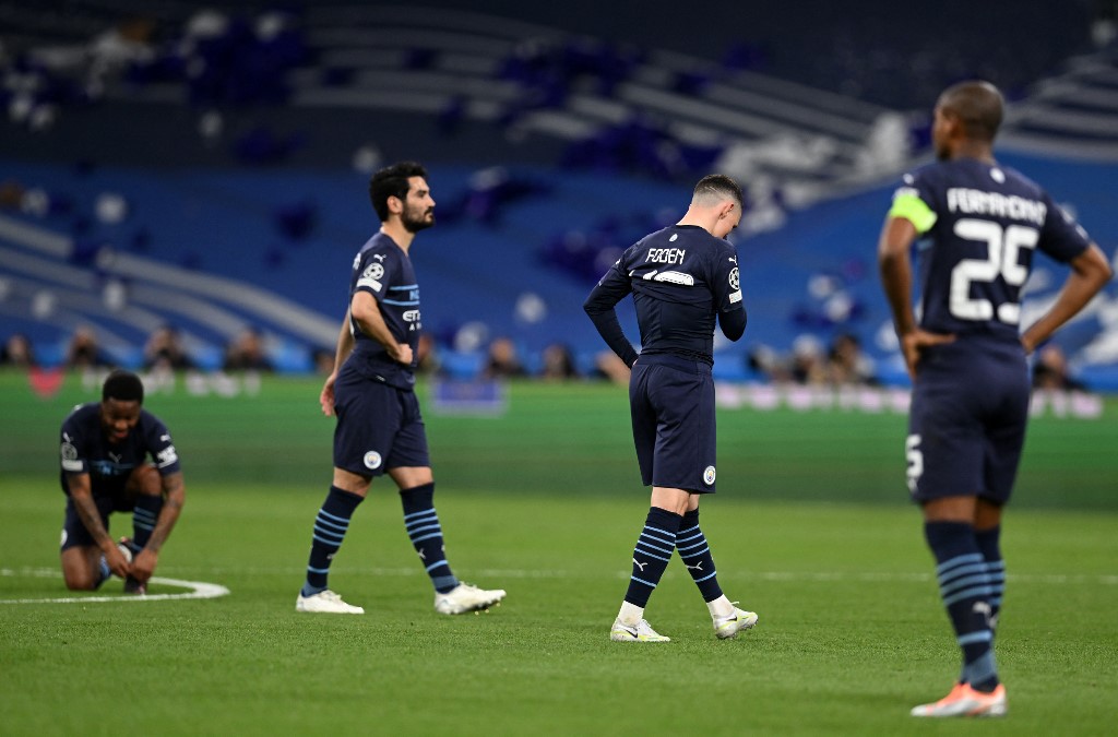 Manchester City's English midfielder Phil Foden (2R) reacts after the UEFA Champions League semi-final second leg football match between Real Madrid CF and Manchester City at the Santiago Bernabeu stadium in Madrid on May 4, 2022. - Real Madrid won the match 3-1.