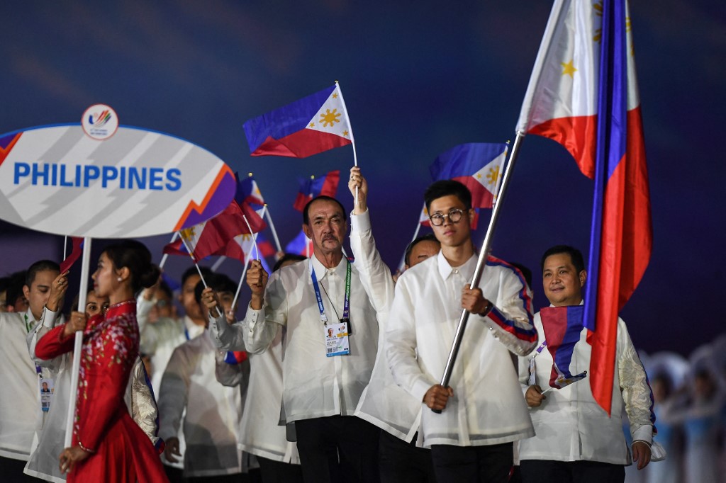 Members of the Philippines contingent hold their national flags during the opening ceremony of the 31st Southeast Asian Games (SEA Games) at the My Dinh National Stadium in Hanoi on May 12, 2022. 