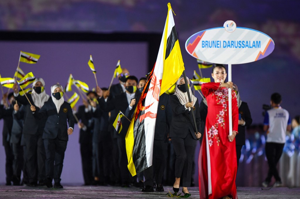 Members of the Brunei contingent hold their national flags during the opening ceremony of the 31st Southeast Asian Games (SEA Games) at the My Dinh National Stadium in Hanoi on May 12, 2022. (Photo by Nhac NGUYEN / AFP)