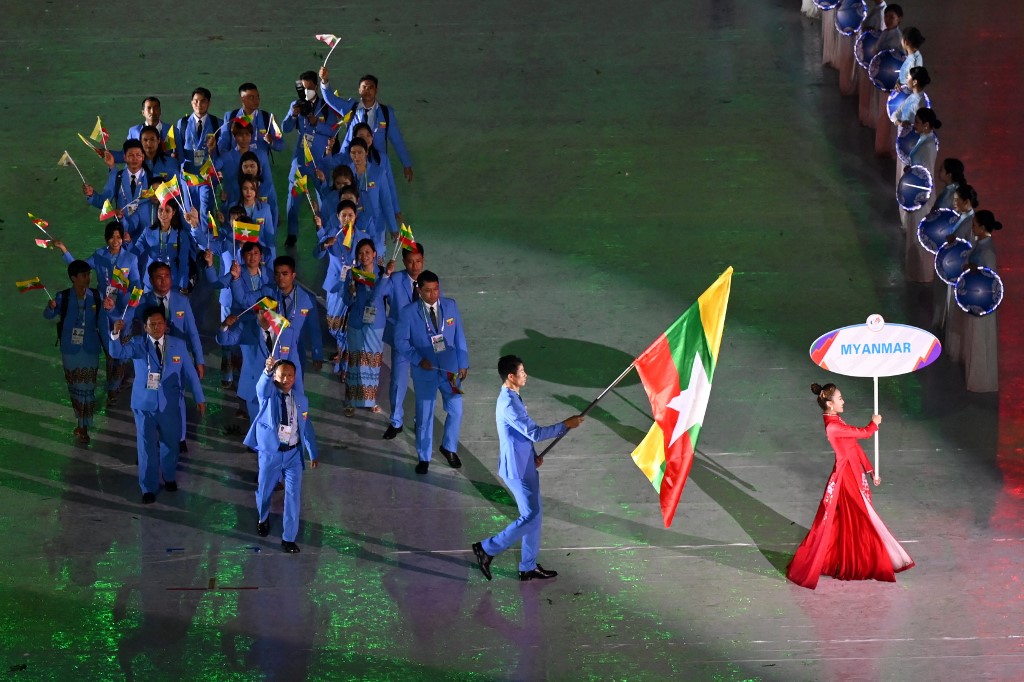 Members of the Myanmar contingent hold their national flags during the opening ceremony of the 31st Southeast Asian Games (SEA Games) at the My Dinh National Stadium in Hanoi on May 12, 2022. (Photo by Ye Aung THU / AFP)