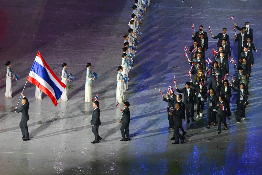 Members of the Thailand contingent hold their national flags during the opening ceremony of the 31st Southeast Asian Games (SEA Games) at the My Dinh National Stadium in Hanoi on May 12, 2022. (Photo by Ye Aung THU / AFP)