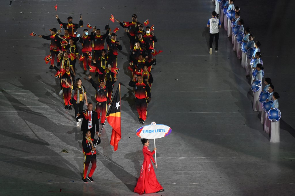Members of the East Timor contingent wave their national flags during the opening ceremony of the 31st Southeast Asian Games (SEA Games) at the My Dinh National Stadium in Hanoi on May 12, 2022. (Photo by Ye Aung THU / AFP)