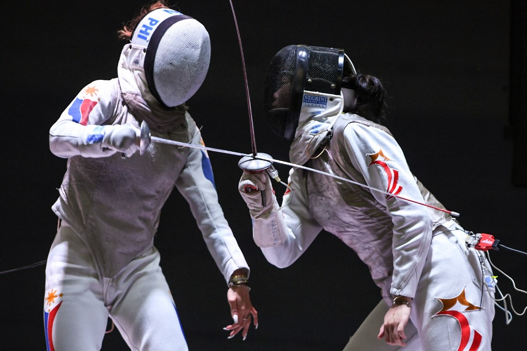 Philippines' Maxine Isabel Esteban (L) competes with Singapore's Denyse Chan Wan Jing in the women's foil team fencing final during the 31st Southeast Asian Games (SEA Games) in Hanoi on May 17, 2022. (Photo by TANG CHHIN SOTHY / AFP) / The erroneous mention[s] appearing in the metadata of this photo by TANG CHHIN SOTHY has been modified in AFP systems in the following manner: [Denyse Chan Wan Jing] instead of [Cheung Kemei]. Please immediately remove the erroneous mention[s] from all your online services and delete it (them) from your servers. If you have been authorized by AFP to distribute it (them) to third parties, please ensure that the same actions are carried out by them. Failure to promptly comply with these instructions will entail liability on your part for any continued or post notification usage. Therefore we thank you very much for all your attention and prompt action. We are sorry for the inconvenience this notification may cause and remain at your disposal for any further information you may require.