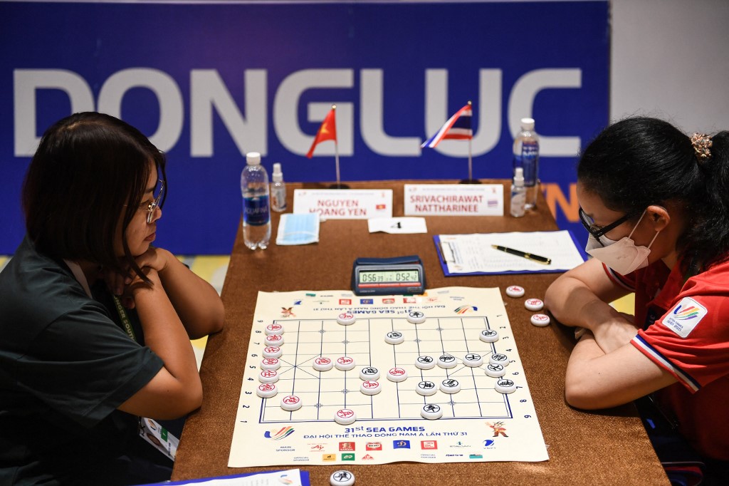 Vietnam's Nguyen Hoang Yen (L) competes with Thailand's Nattharinee Srivachirawat in the women's standard single xiangqi event during the 31st Southeast Asian Games (SEA Games) in Hanoi on May 18, 2022. (Photo by Nhac NGUYEN / AFP)