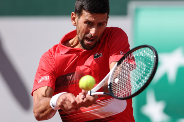 Serbia's Novak Djokovic returns to Slovakia's Alex Molcan during their men's singles match on day four of the Roland-Garros Open tennis tournament at the Court Suzanne-Lenglen in Paris on May 25, 2022. (Photo by Thomas SAMSON / AFP)