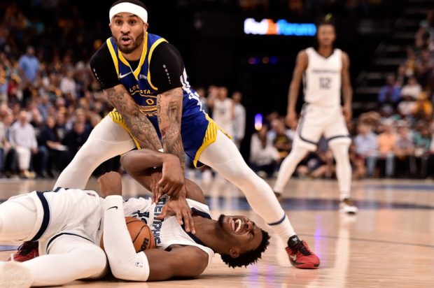 Gary Payton II #0 of the Golden State Warriors and Jaren Jackson Jr.  #13 of the Memphis Grizzlies scramble for the ball during Game One of the Western Conference Semifinals of the NBA Playoffs Qualifiers at FedExForum on May 1, 2022 in Memphis, Tennessee.