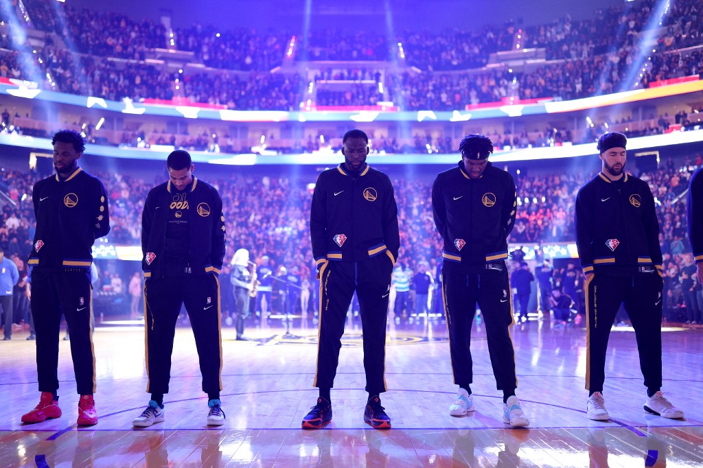 (L-R) Andrew Wiggins #22, Jordan Poole #3, Draymond Green #23, Kevon Looney #5, and Klay Thompson #11 of the Golden State Warriors stand for the national anthem before Game Five of the Western Conference First Round NBA Playoffs against the Denver 