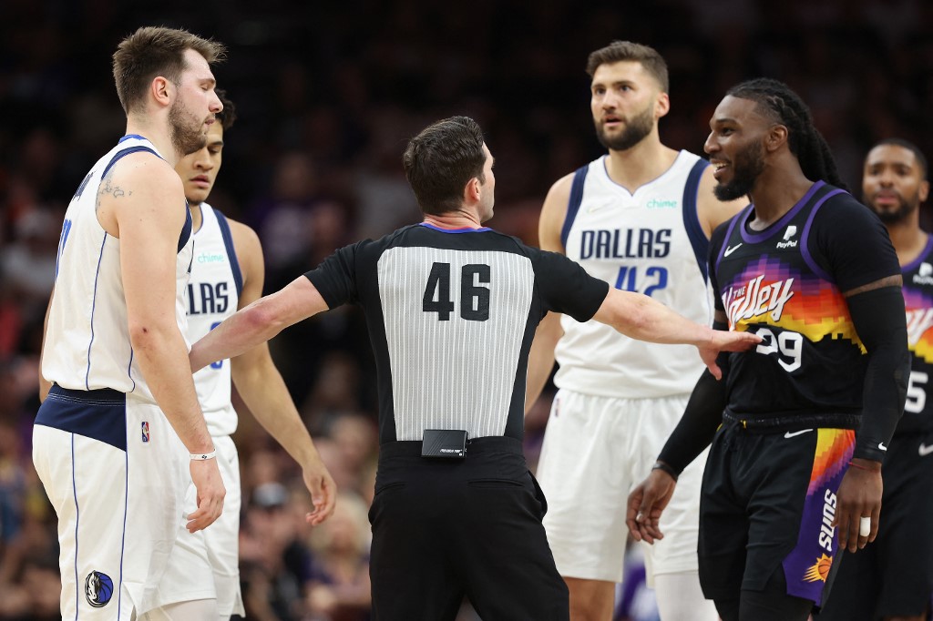 Luka Doncic #77 of the Dallas Mavericks and Jae Crowder #99 of the Phoenix Suns are separated by referee Ben Taylor #46 during the first half of Game Two of the Western Conference Second Round NBA Playoffs at Footprint Center on May 04, 2022 in Phoenix, Arizona. NOTE TO USER: User 