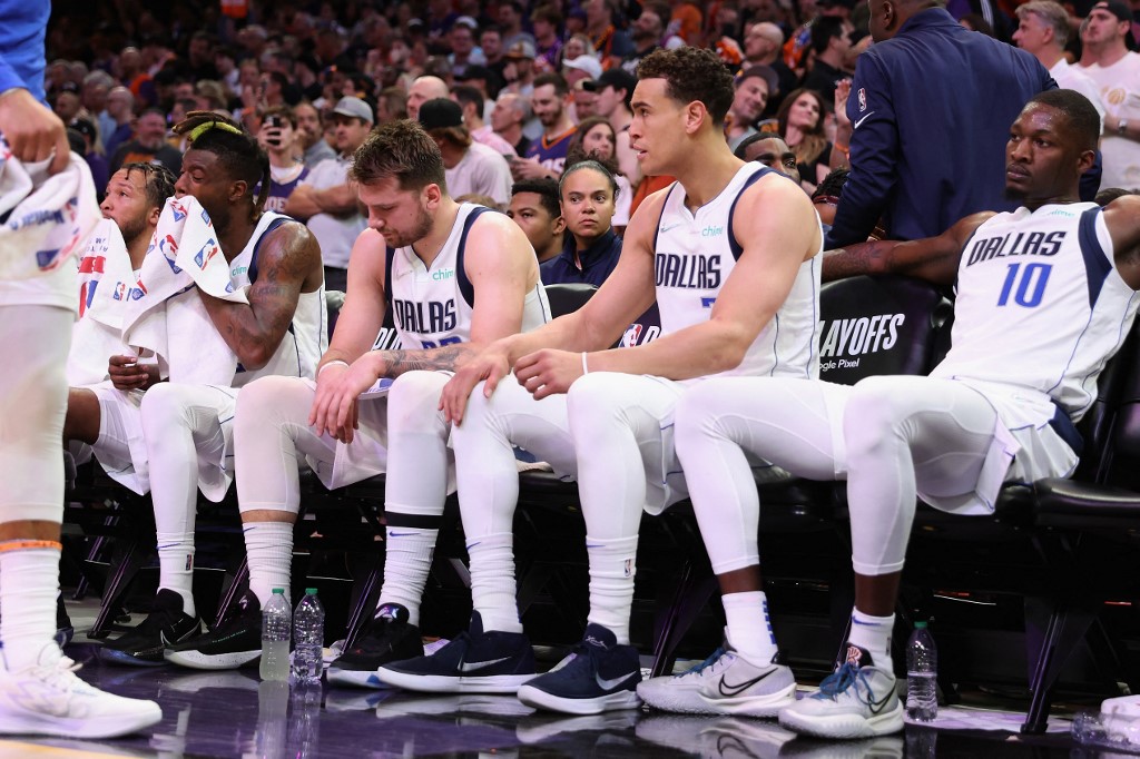 Reggie Bullock #25, Luka Doncic #77, Dwight Powell #7 and Dorian Finney-Smith #10 of the Dallas Mavericks react on the bench during the second half of Game Two of the Western Conference Second Round NBA Playoffs at Footprint Center on May 04, 2022 in Phoenix, Arizona.