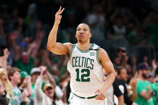 Grant Williams #12 of the Boston Celtics reacts after making a three point basket during the third quarter against the Milwaukee Bucks in Game Seven of the 2022 NBA Playoffs Eastern Conference Semifinals at TD Garden on May 15, 2022 in Boston, Massachusetts. NOTE TO USER: User expressly acknowledges and agrees that, by downloading and/or using this photograph, User is consenting to the terms and conditions of the Getty Images License Agreement.   Adam Glanzman/Getty Images/AFP (Photo by Adam Glanzman / GETTY IMAGES NORTH AMERICA / Getty Images via AFP)