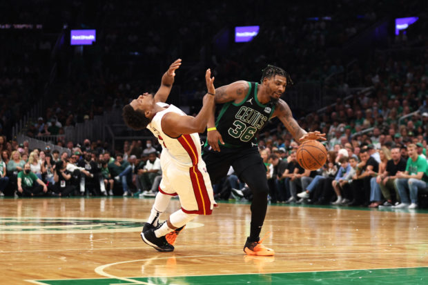 Marcus Smart #36 of the Boston Celtics dribbles against Kyle Lowry #7 of the