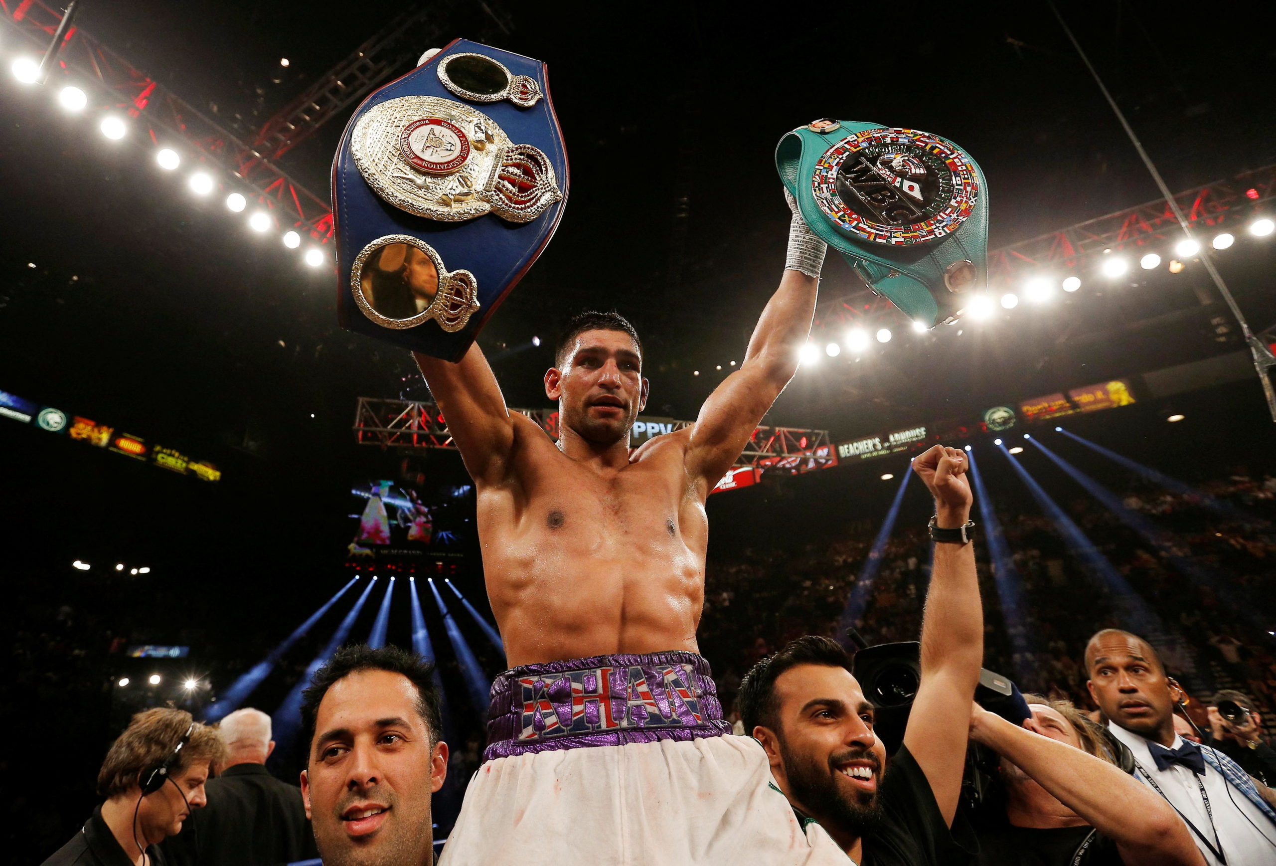 FILE PHOTO: Boxing - Luis Collazo v Amir Khan WBA International Welterweight Title - MGM Grand Garden Arena, Las Vegas, United States of America - 3/5/14   Amir Khan celebrates winning the fight with the title belts  