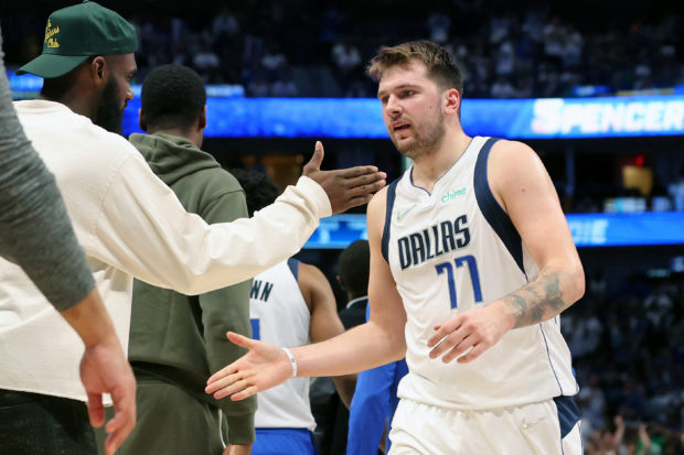May 24, 2022; Dallas, Texas, USA; Dallas Mavericks guard Luka Doncic (77) is congratulated after a play against the Golden State Warriors during a time out during the third quarter in game four of the 2022 Western Conference finals at American Airlines Center. Mandatory Credit: Kevin Jairaj-USA TODAY Sports