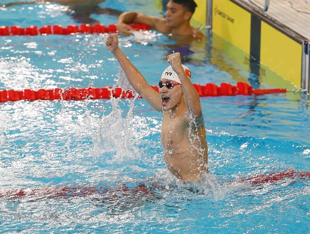 Pham Thanh Bao celebrates his men's 100m breaststroke win at the 31st SEA Games in Hanoi on Saturday. — VNA/VNS Photo Phạm Kiên via ANN