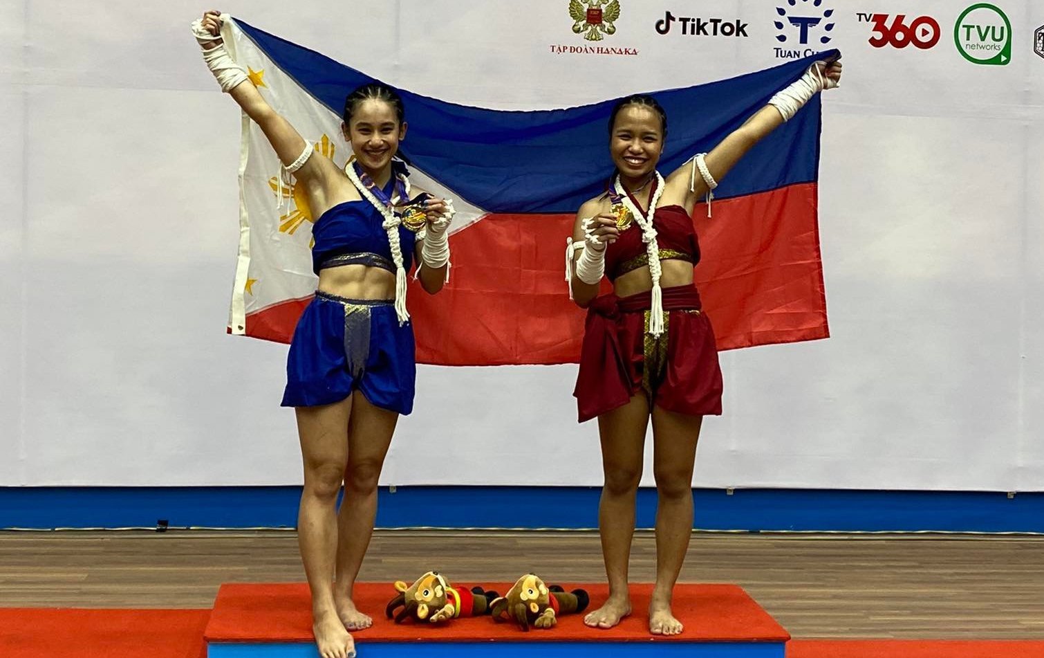 Muay gold medalists Islay Erika Bomogao and Rhichein Yosorez.  Photo via Muaythai Association of the Philippines 