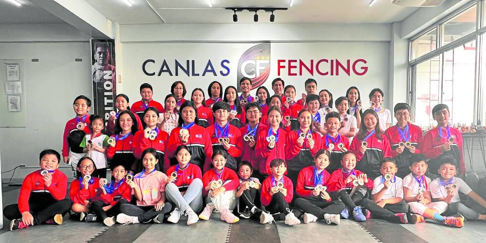 Canlas Fencing bets show off their medals after their recent competition