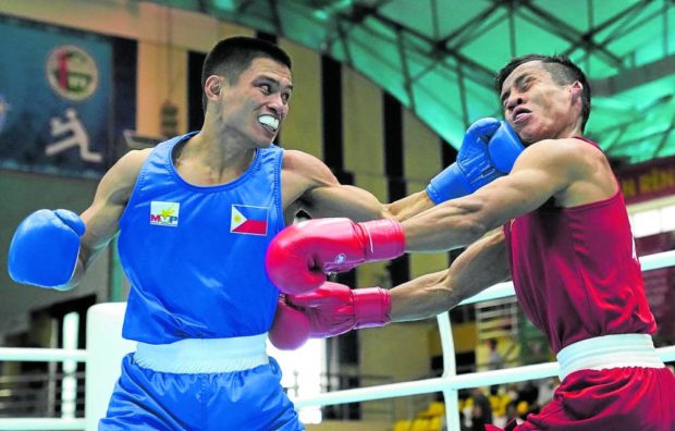 Ian Clark Bautista asesta un golpe a Naing Latt de Myanmar en su enfrentamiento por la medalla de oro.  —REUTERS