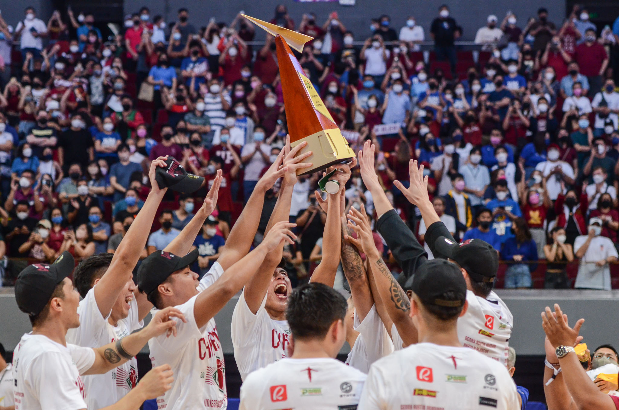 The UP Fighting Maroons lift the UAAP trophy after clinching the men's basketball championship. UAAP PHOTO