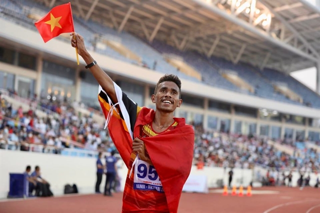 With a Vietnamese flag in his hand, Felisberto de Deus celebrates after winning the second silver medal for Timor Leste. VNA/VNS via ANN