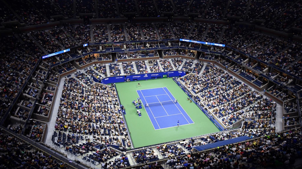 (FILES) In this file photo taken on August 31, 2021 an overview shows Arthur Ashe Stadium during the 2021 US Open Tennis tournament men's singles first round match between Serbia's Novak Djokovic (bottom) and Denmark's Holger Rune at the USTA Billie Jean King National Tennis Center in New York. - Players from Russia and Belarus will be allowed to compete in the 2022 US Open, but only under a neutral flag, the US Tennis Association announced June 14, 2022. (Photo by ANGELA  WEISS / AFP)