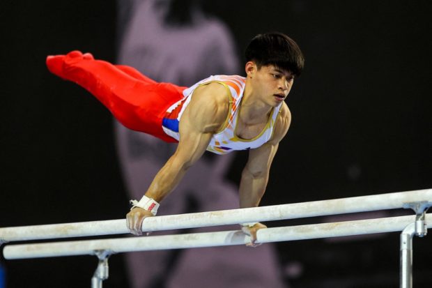 The Philippines' Carlos Edriel Yulo competes in the men's parallel bars competition during the ninth Artistic Gymnastics Asian Championships in Qatar's capital Doha on June 18, 2022. (