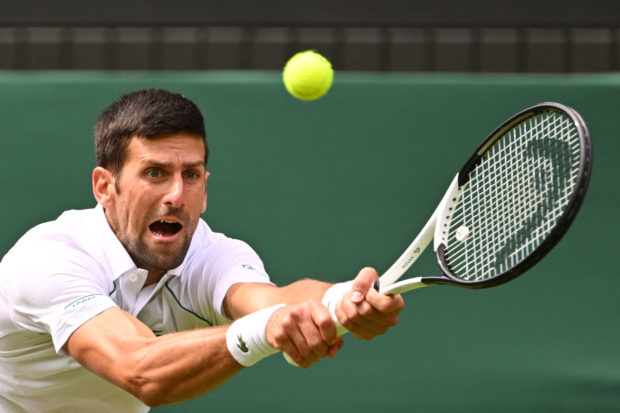Novak Djokovic of Serbia returns the ball to Thanasi Kokkinakis of Australia during their men's singles tennis match on day three of the 2022 Wimbledon Championships at the All England Tennis Club in Wimbledon, southwest London, on May 29. June 2022. (Photo by SEBASTIEN BOZON / AFP) / USE LIMITED EDIT