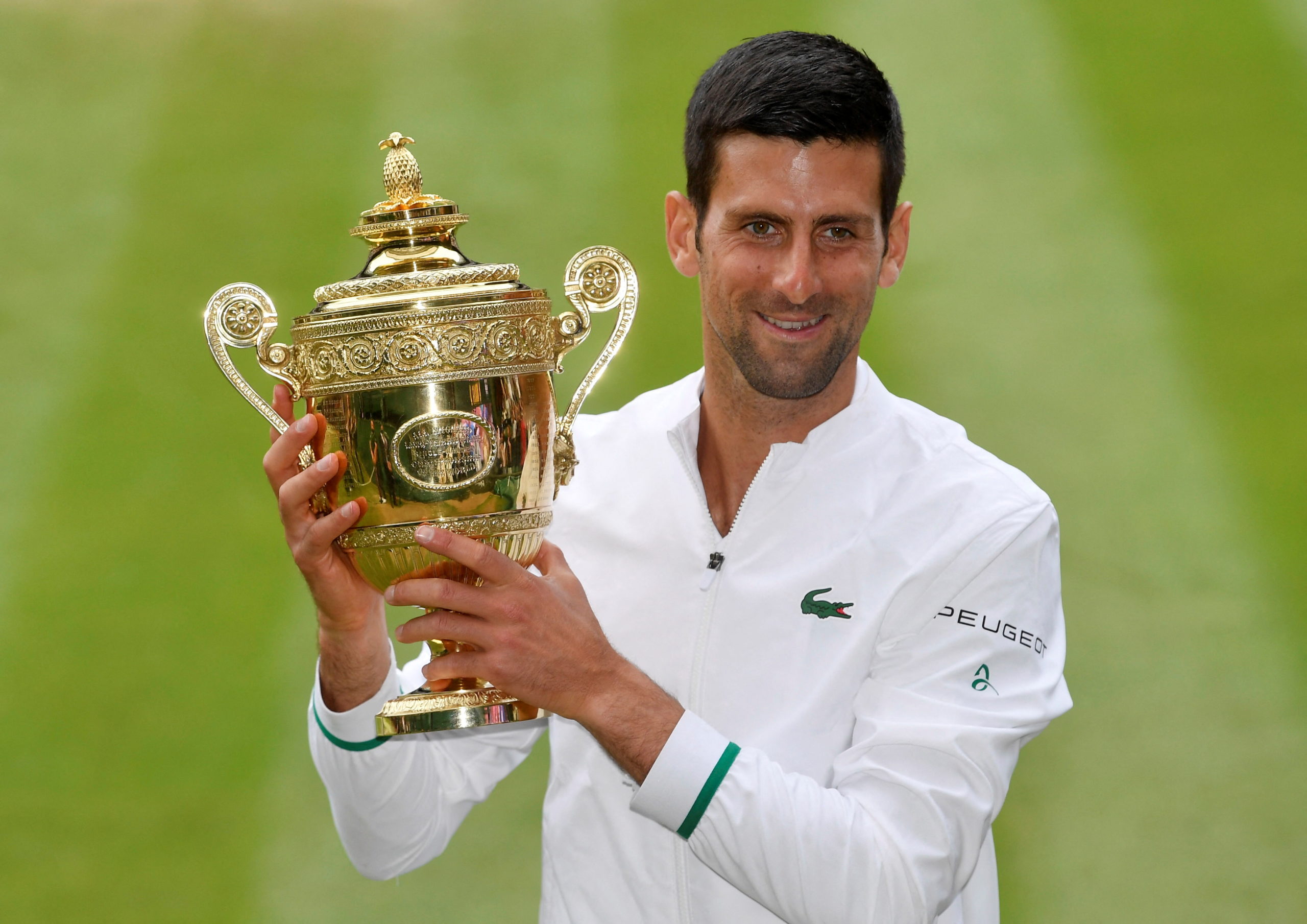 July 11, 2021 Novak Djokovic of Serbia celebrates with the trophy after winning his final match against Matteo Berrettini of Italy 