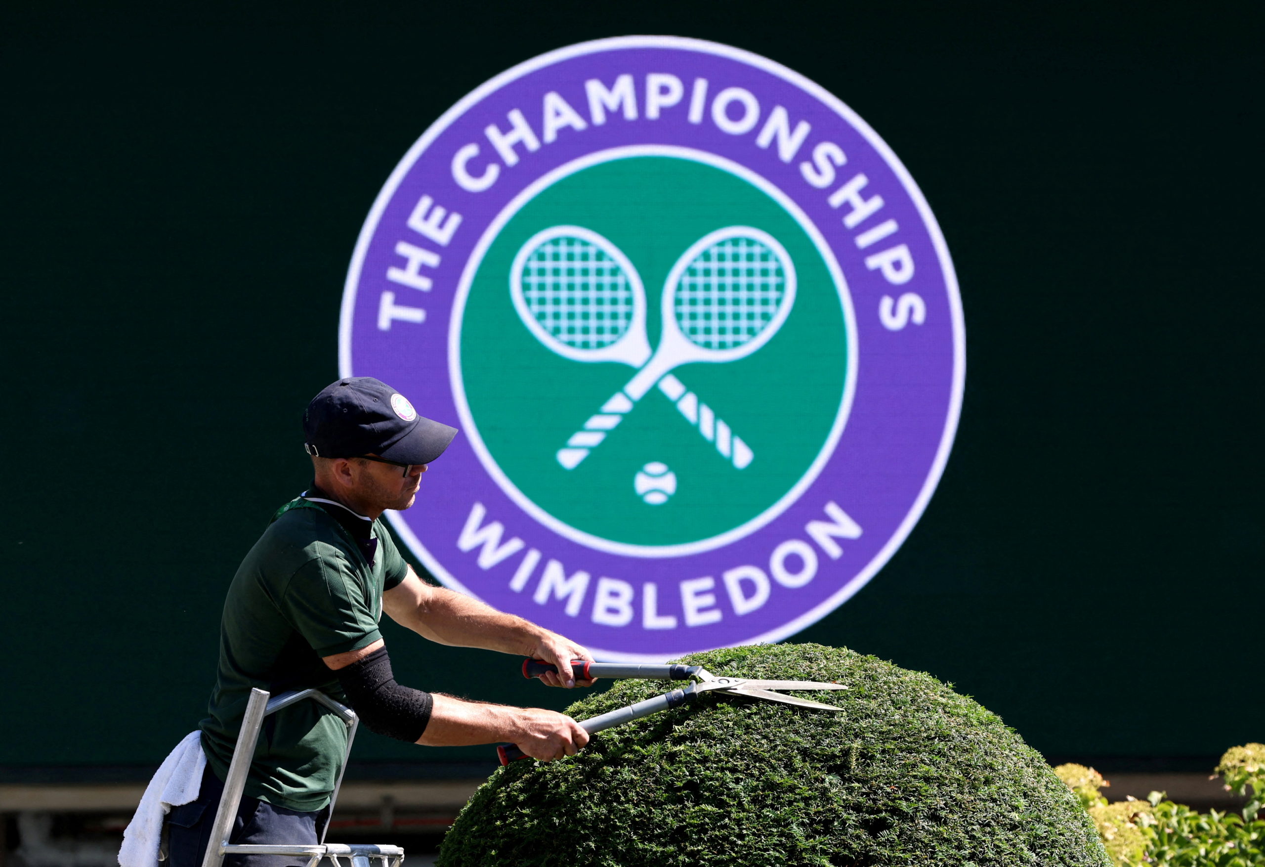 Tennis - Wimbledon Preview - All England Lawn Tennis and Croquet Club, London, Britain - June 22, 2022 General view as a worker cuts a hedge at the All England Lawn Tennis and Croquet Club 