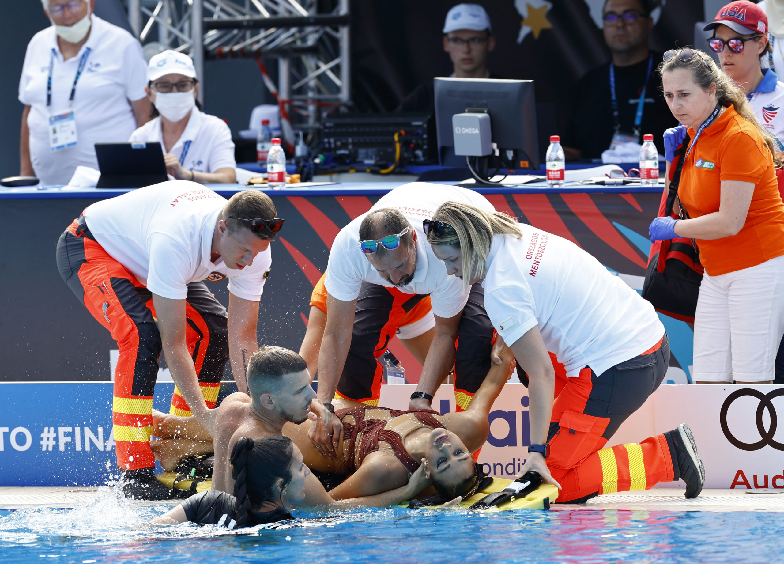Anita Alvarez of the U.S. receives medical attention during the women's solo free final 