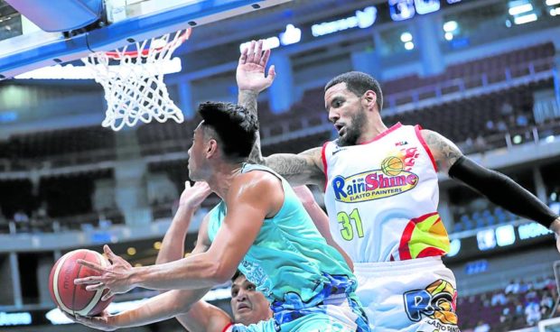 Phoenix's Javey Mocon (left) slips past Nick Demusis for a rematch in the second half of the Fuel Masters' strong victory.  —PICTURES FROM PBA IMAGES