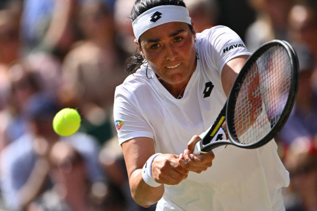 Tunisia's Ons Jabeur returns the ball against Germany's Tatjana Maria during their women's singles semi final tennis match on the eleventh day of the 2022 Wimbledon Championships at The All England Tennis Club in Wimbledon, southwest London, on July 7, 2022. (Photo by SEBASTIEN BOZON / AFP) / RESTRICTED TO EDITORIAL USE