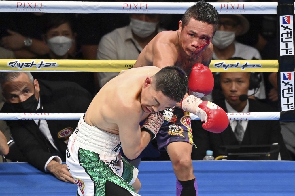 Donnie Nietes of Philippines (back) and Japan's Kazuto Ioka fight during their WBO world super flyweight title match in Tokyo on July 13, 2022. (
