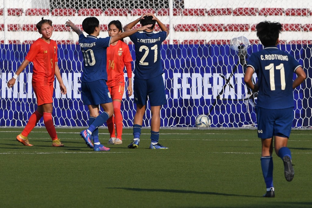 Thailand's players (blue) celebrate a goal against Myanmar during their women's Asian Football Federation (AFF) semi-final match at the Rizal memorial colliseum in Manila on July 15, 2022