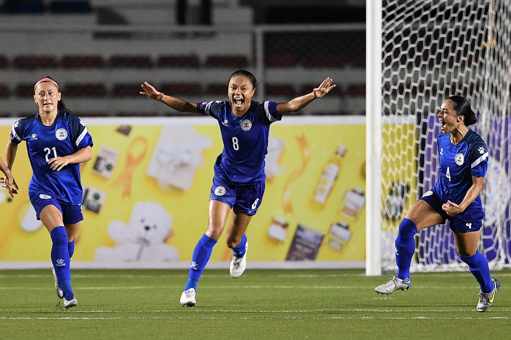 Philippine players celebrate a goal against Vietnam during the Women's Asian Football Federation (AFF) semi-final match at the Rizal memorial colliseum in Manila on July 15, 2022.