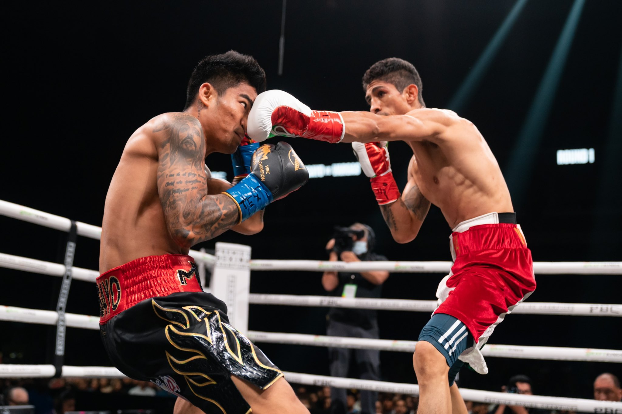 Mark Magsayo takes a punch from Rey Vargas during their WBC featherweight title showdown.