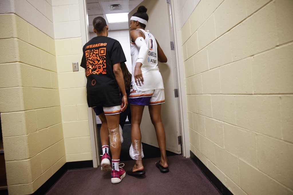 Brittney Griner's teammates from the Phoenix Mercury women's basketball team, Diamond DeShields (R) and Skylar Diggins-Smith (L), leave st the end of a press conference after a game against the Connecticut Sun at Mohegan Sun Arena in Uncasville on August 4, 2022. - 