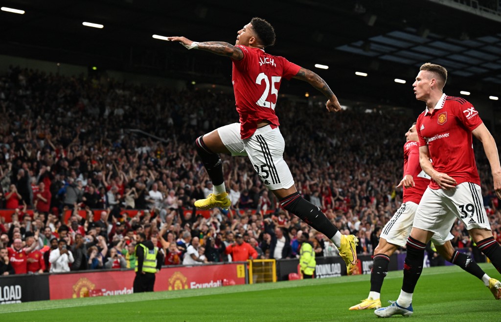 Manchester United's English striker Jadon Sancho (C) celebrates after scoring the opening goal during the English Premier League football match between Manchester United and Liverpool at Old Trafford in Manchester, north west England, on August 22, 2022. 